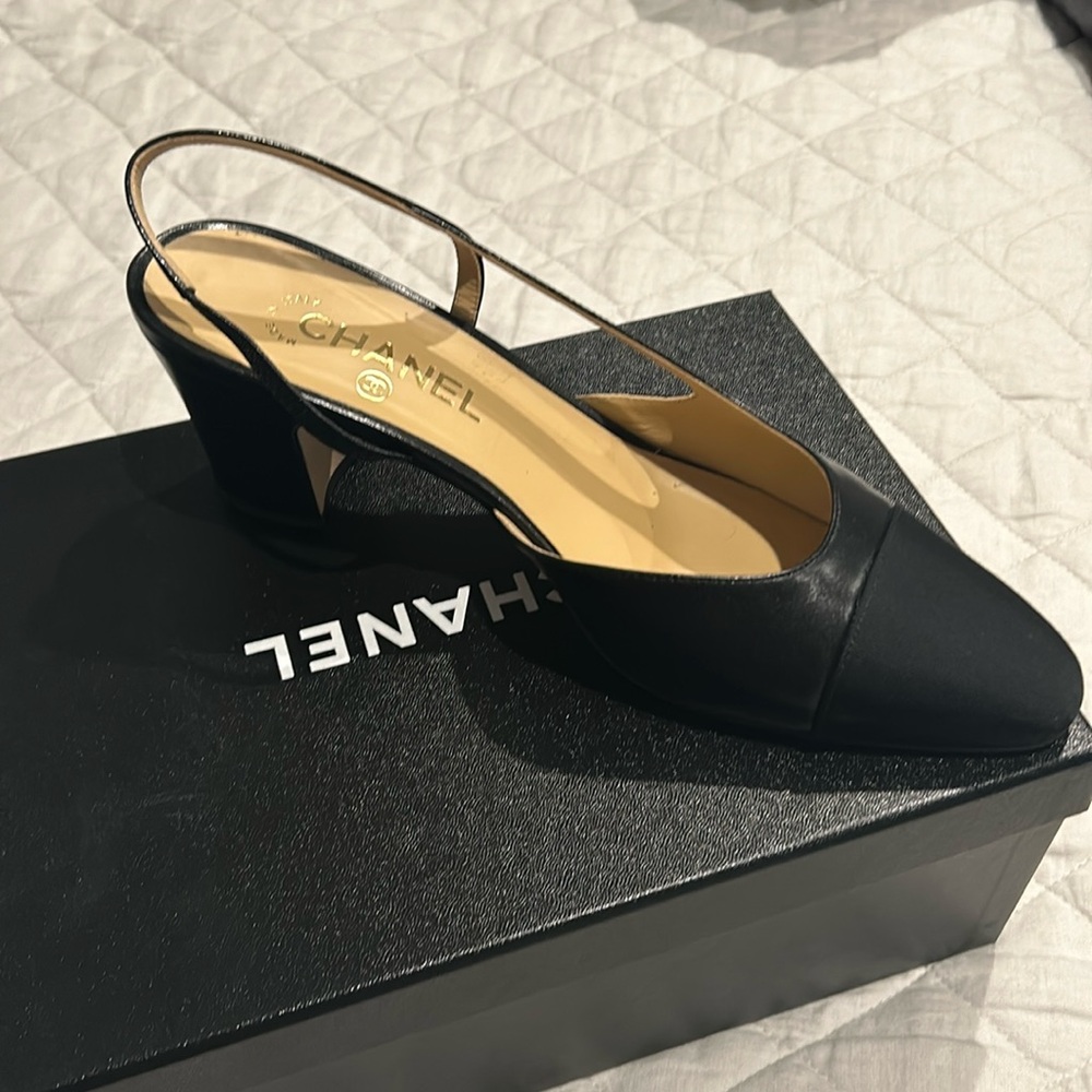Chanel black 2 inch sling back shoe.